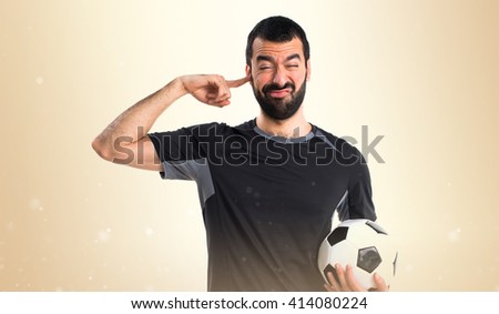 Football player covering his ears