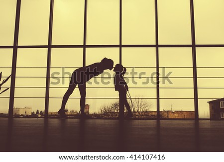 Silhouette of mother and daughter in the gym.high five.