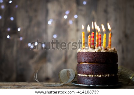 Chocolate birthday cake with candles Royalty-Free Stock Photo #414108739