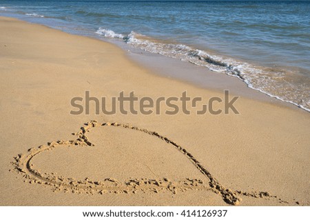 Valentine's love heart on the beach sand. Honeymoon vacations and Valentine's Day theme