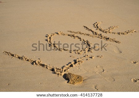 The word Love drawn on the beach sand. Honeymoon vacations and Valentine's Day theme