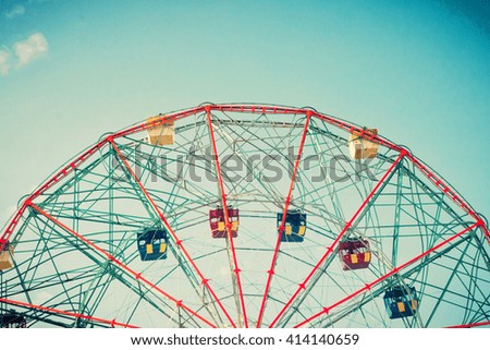 Vintage colorful ferris wheel over blue sky