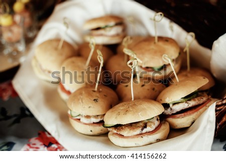 rustic catering service buffet table with delicious burgers Royalty-Free Stock Photo #414156262