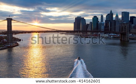 Panoramic view of Brooklyn Bridge and Manhattan Skyline at sunset in New York City