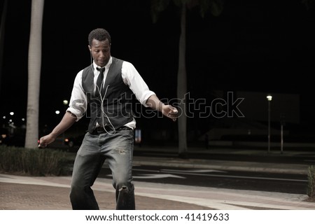 Young African American male dancing in the street