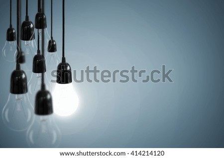 Idea concept with light bulb on the background blue color.