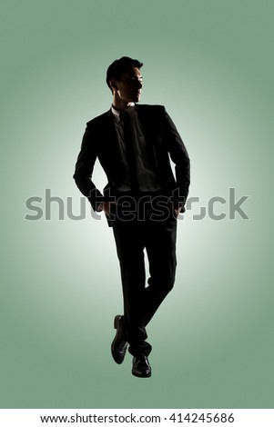 Silhouette of Asian businessman dancing or posing, isolated