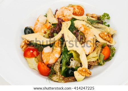 Fresh mixed green salad with shrimps, cherry tomatoes and olives isolated on white bachground