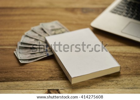 Book with money and laptop