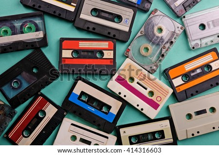 Set of old audio cassettes on blue background Royalty-Free Stock Photo #414316603