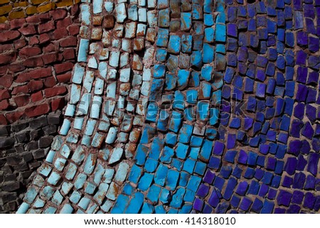 Wall decorated with mosaic tiles and colored bricks Picture taken without a vignette in bright colors.. A whimsical pattern. It can be used as the background or texture for any photo editor.
