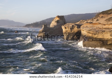 Stormy waves crashing on the rocky shores of Oregon Coast. Picture taken in Cape Kiwanda, Pacific City, Or,USA.