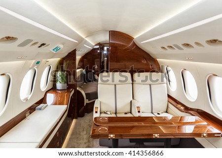 Luxury interior in bright colors of genuine leather in the business jet Royalty-Free Stock Photo #414356866