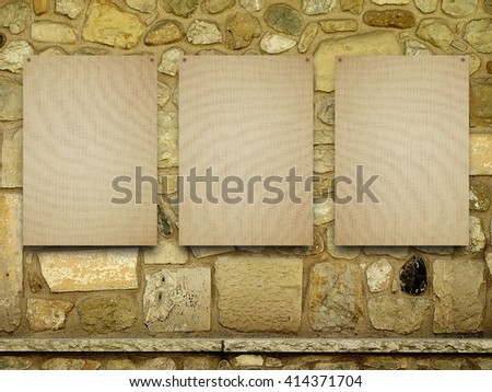 Close-up of three nailed blank brown canvas frame on old brown stone wall background