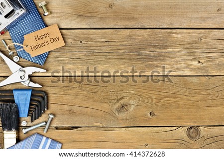 Happy Fathers Day gift tag with side border of tools and ties on a rustic wood background Royalty-Free Stock Photo #414372628