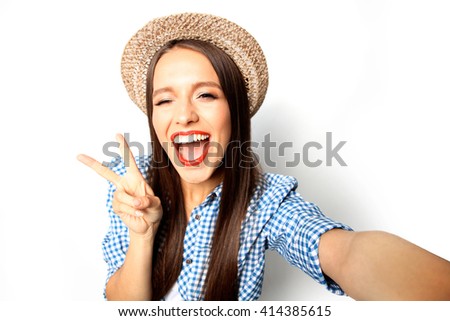 Pretty hipster girl taking selfie