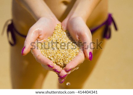Woman hands holding sand on the beach