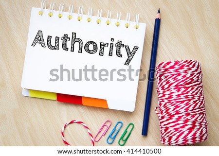 authority, text message on white paper and pencil on wood table / business concept