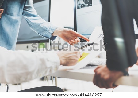 Business meeting brainstorming,photo documents holding hands. Photo account managers crew working with new startup project.Idea presentation, analyze marketing plans.Blurred, film effect, horizontal