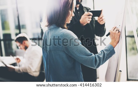 Business meeting.Photo account managers working with new startup project. Manager holding modern smartphone hands.Woman drawing Idea presentation,analyze marketing plans.Blurred,film effect.Horizontal