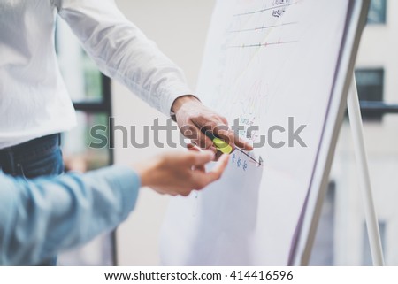Business meeting office.Closeup photo man showing statistics info chart board.Photo account managers crew working with new startup project.Idea presentation,analyze marketing plan.Blurred,film effect.