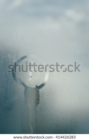 Drawing of lamp icon inscription on foggy window glass. Idea or ecology concept