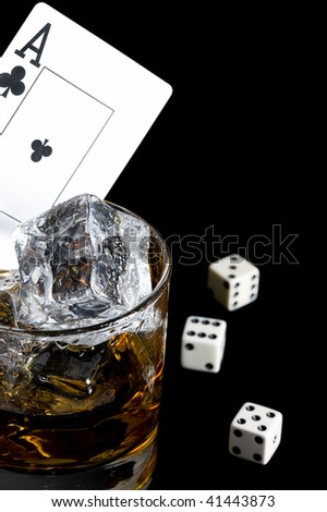 Whisky and playing card in black background. Game object