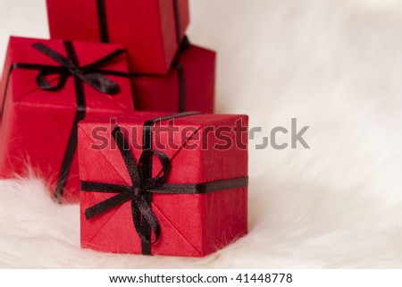 red gift boxes on white fur background