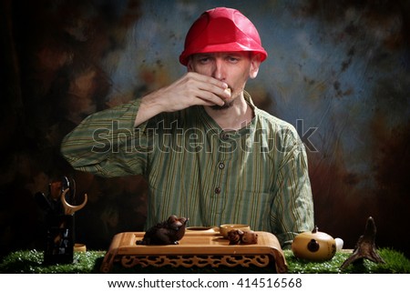 close-up portrait of a tea master in the studio against a dark background