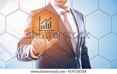 business, technology, internet and e-business concept. Businessman pressing graph button on virtual screens with hexagons and transparent honeycomb