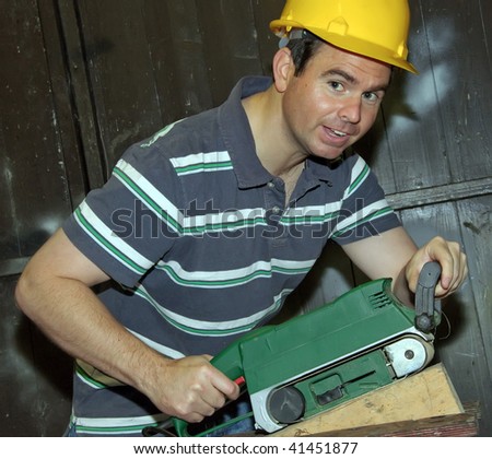 picture of male working on electrical sanding and cutting timber