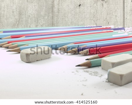 The writing tools on concrete wall background