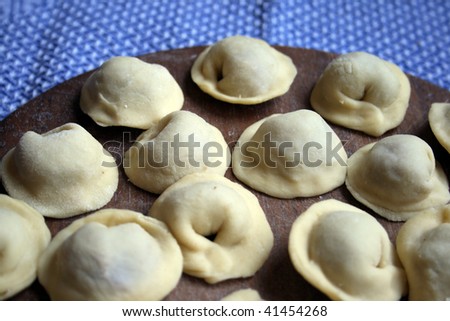 Pel'menis or raviolli with meat - a dish characteristic for the Italian, Russian, Ukrainian and Chinese kitchen. In this picture - the home made Russian pel'menis.