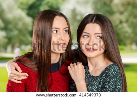 Two women gossip