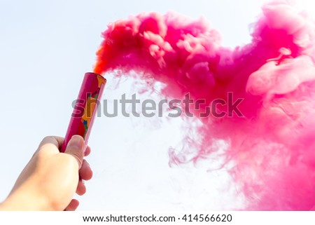 Hand on Smoke Stick for help SOS - soft focus Royalty-Free Stock Photo #414566620