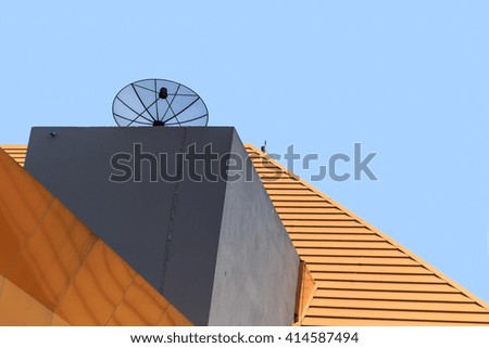 Picture of parabolic satellite dish on the modern building roof.