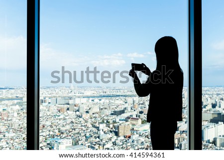 Silhouette of woman shooting photo 