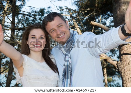 Summer sunny couple portrait on a background of blue water on the beach. doing selfie and enjoy free time holidays.
