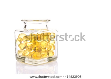 Fish oil capsules in translucent bottle on white background