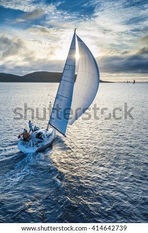 Sailing boat in light wind from bird`s eye view Royalty-Free Stock Photo #414642739