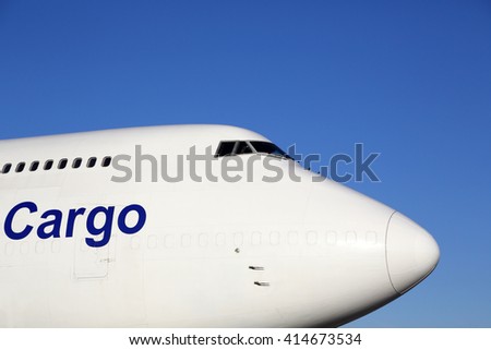 Civil cargo airplane standing on a parking place. Royalty-Free Stock Photo #414673534