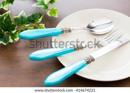 Fork, knife and spoon on a plate