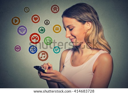 Woman using app on smart phone isolated gray background. Communication technology mobile high tech concept. Girl texting on smartphone with social media application symbols icons flying out of screen 
