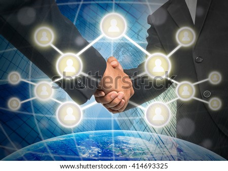 Business handshake with Social media symbol over the building and world map background, Elements of this image furnished by NASA, Business social netwok concept