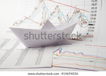 Business concept, Paper boat floats on documents