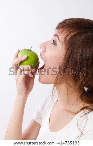 healthy asian woman on border, biting or eating green apple