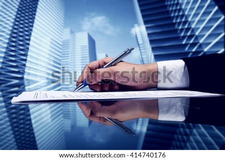 Businessman signing a document on futuristic skyscrapers background