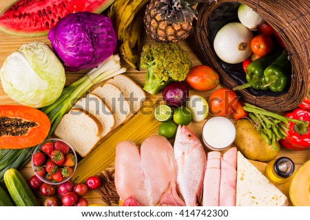 table full of all kinds of food in our daily diet includes proteins, carbohydrates, fats, vegetables and fruits Royalty-Free Stock Photo #414742300