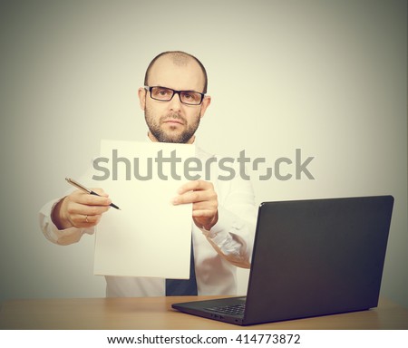 Please sign here. Portrait man in formalwear stretching out clipboard with paper and pointing it with pen while.Isolated on  gray background