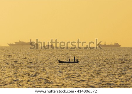 Silhouette of Boats in the sea at sunset time. - Shallow of focus